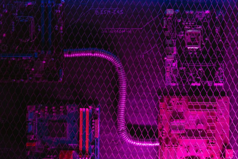 Dark, modern tech workspace with glowing blue and purple ambient lighting, a sleek laptop displaying a website being built, subtle grid or circuit-board pattern overlay suggesting AI and innovation